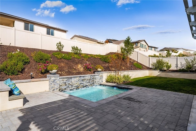 view of swimming pool with a fenced in pool, a residential view, a fenced backyard, and a patio