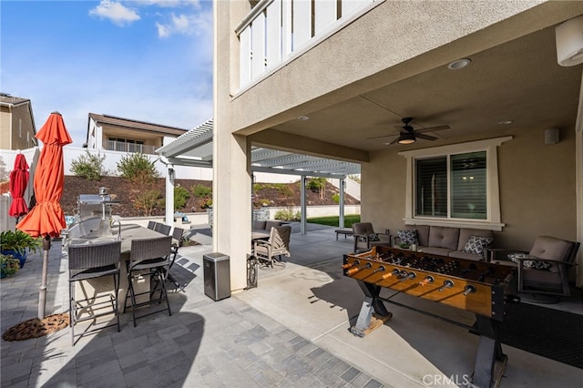 view of patio with a ceiling fan, outdoor dining area, and outdoor lounge area