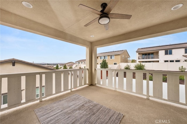 balcony featuring a residential view and ceiling fan