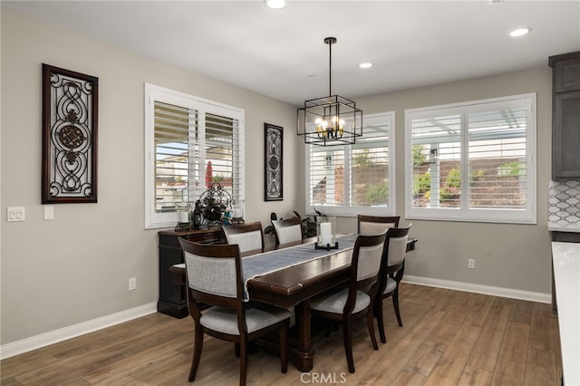 dining room featuring baseboards, a wealth of natural light, and wood finished floors