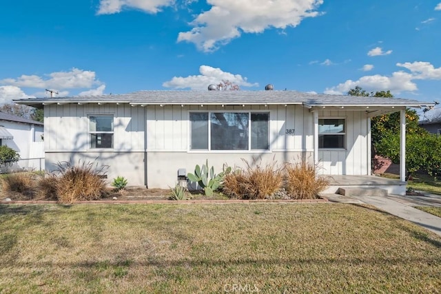 back of property featuring a yard