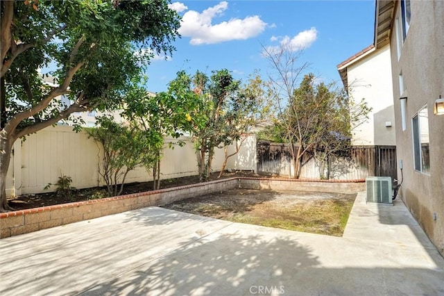 view of yard featuring cooling unit and a patio