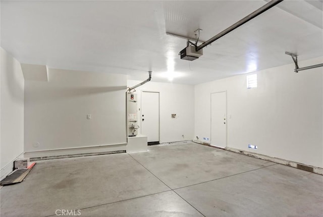 garage featuring a garage door opener and water heater