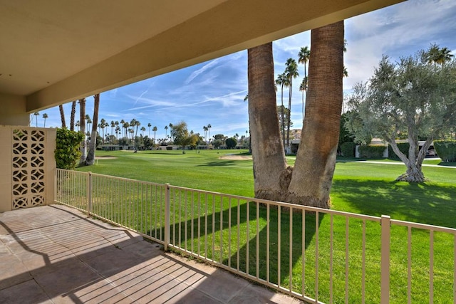 wooden terrace featuring a lawn