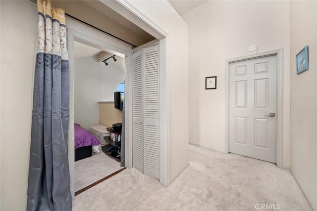 corridor with light colored carpet