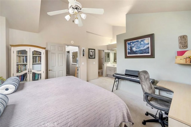 bedroom with ensuite bath, ceiling fan, high vaulted ceiling, light carpet, and french doors