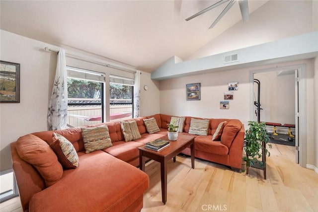 living room featuring ceiling fan, lofted ceiling, and light hardwood / wood-style flooring