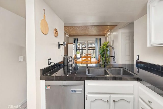 kitchen featuring white cabinetry, stainless steel dishwasher, and sink