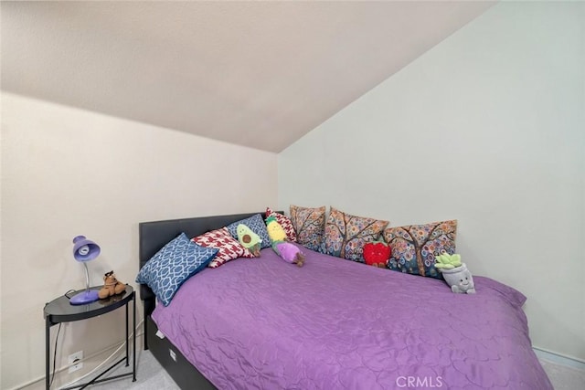 bedroom with vaulted ceiling and light carpet