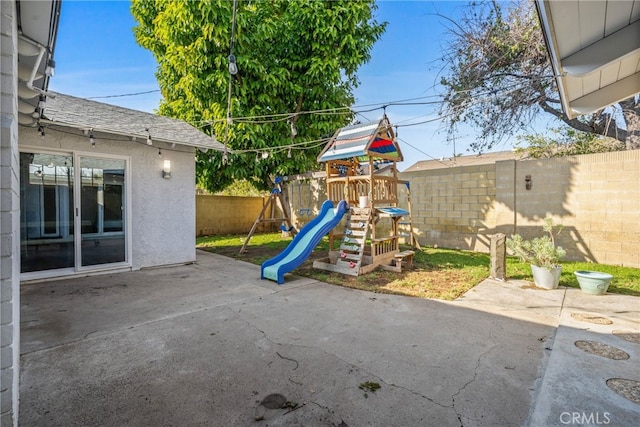 view of jungle gym with a patio