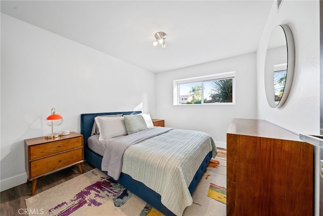 bedroom with dark hardwood / wood-style flooring