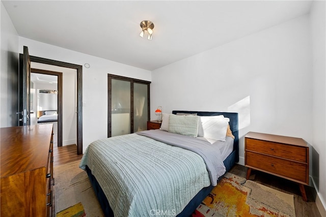 bedroom featuring hardwood / wood-style floors and a closet