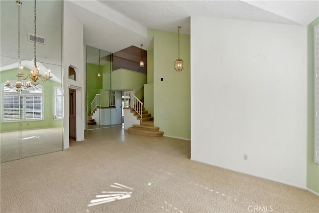 carpeted spare room featuring a high ceiling