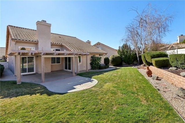 back of house with a pergola, a yard, and a patio area