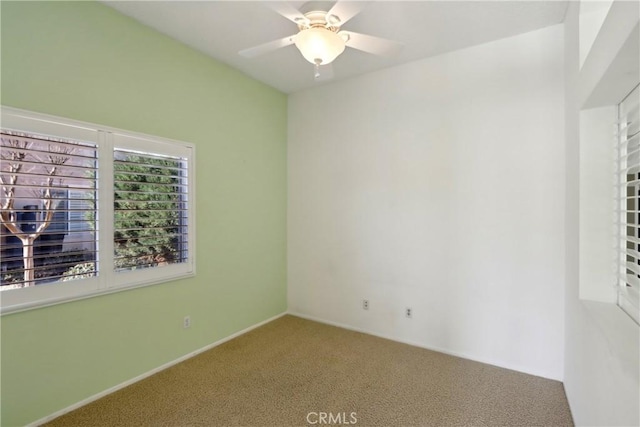 carpeted empty room featuring ceiling fan