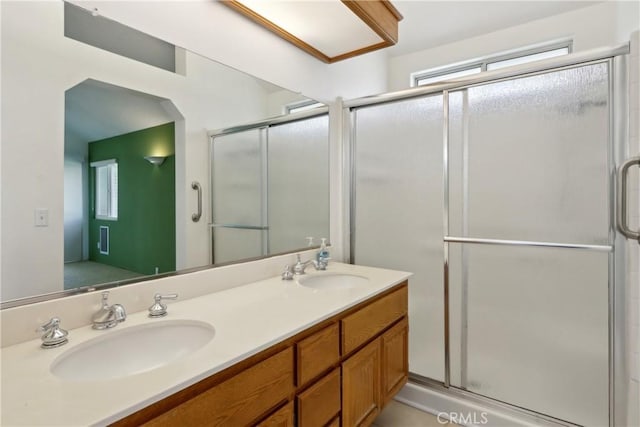 bathroom featuring vanity and a shower with shower door