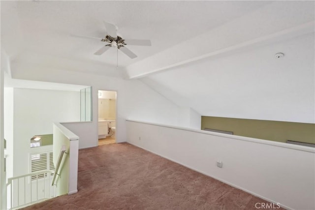 additional living space with vaulted ceiling with beams, ceiling fan, and carpet