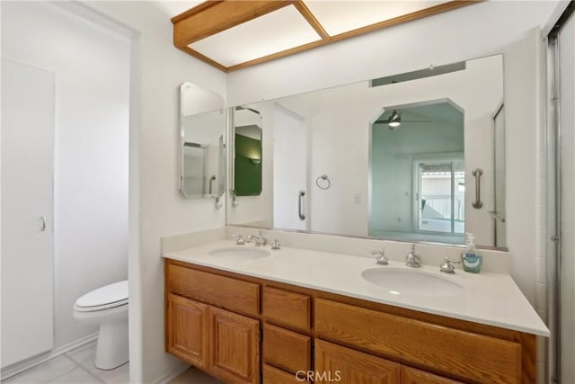 bathroom featuring vanity, toilet, and tile patterned flooring