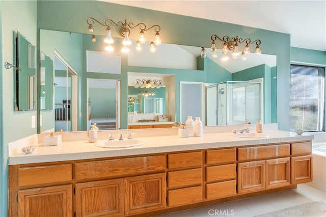 bathroom featuring tile patterned flooring, shower with separate bathtub, vaulted ceiling, and vanity