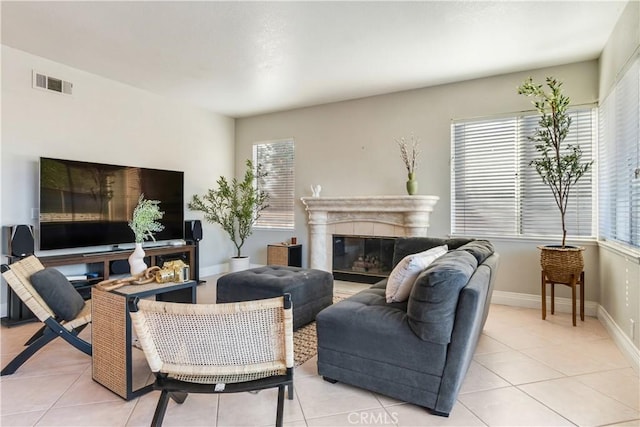 tiled living room featuring a premium fireplace