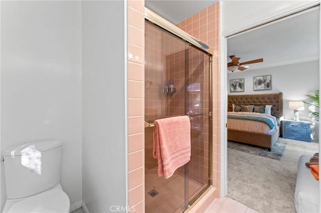 bathroom with walk in shower, ceiling fan, and toilet