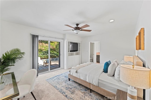 bedroom with access to exterior, ensuite bath, light colored carpet, and ceiling fan