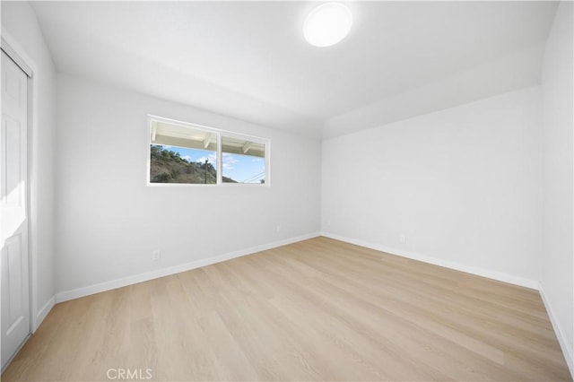 empty room with light hardwood / wood-style flooring