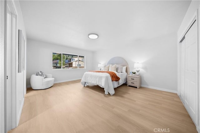 bedroom featuring a closet and light wood-type flooring