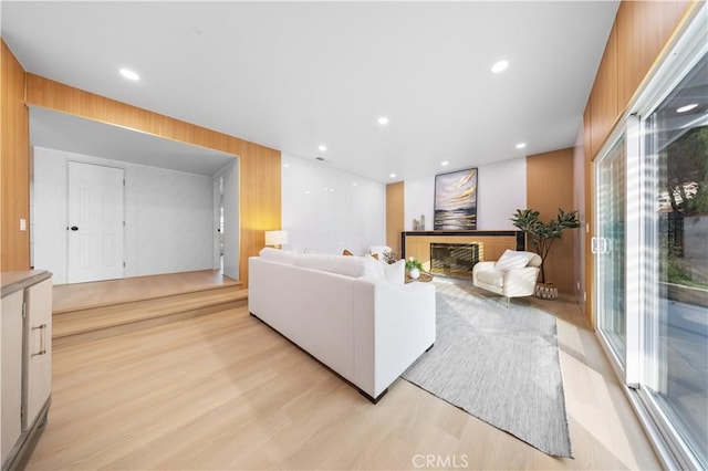 living room featuring wooden walls and light wood-type flooring