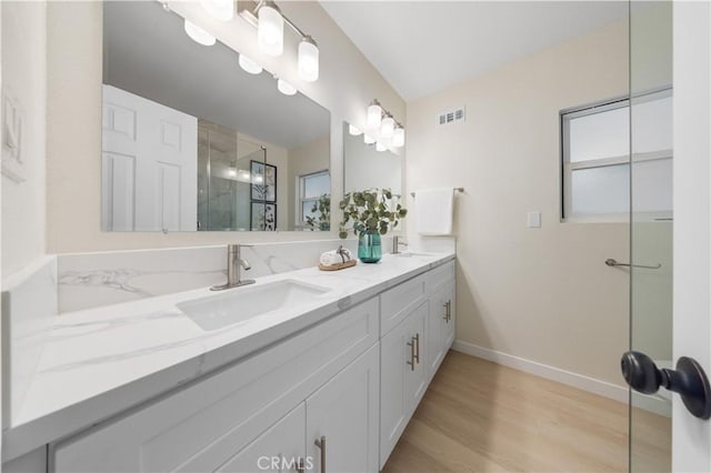 bathroom featuring vanity, a shower with shower door, and hardwood / wood-style floors