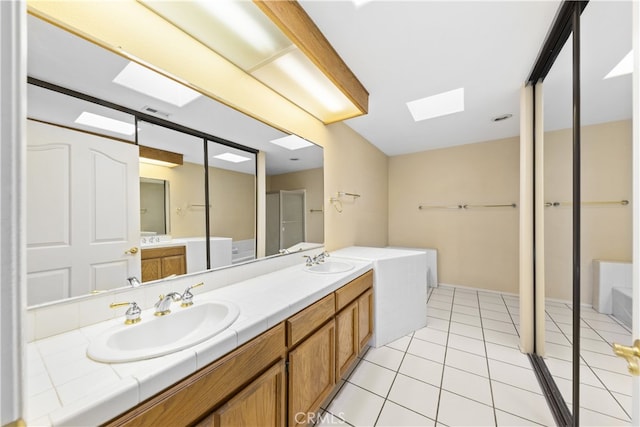 bathroom with vanity, a tub to relax in, and tile patterned floors