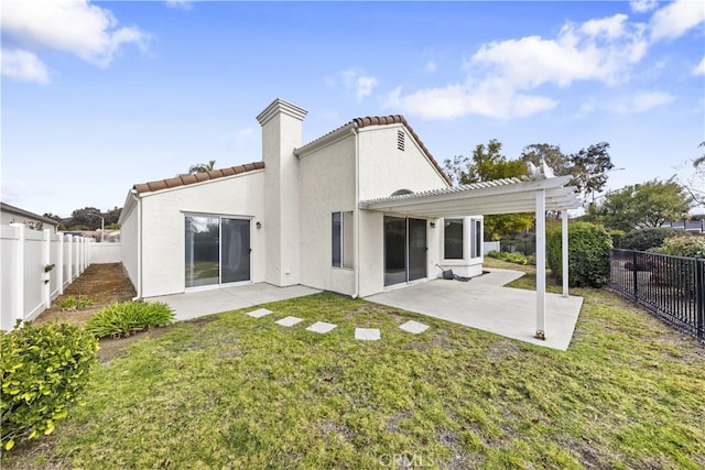 rear view of house featuring a patio, a yard, and a pergola