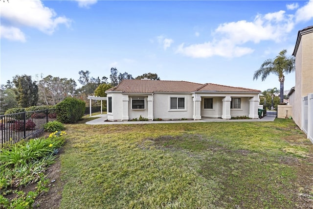 rear view of house featuring a pergola and a lawn