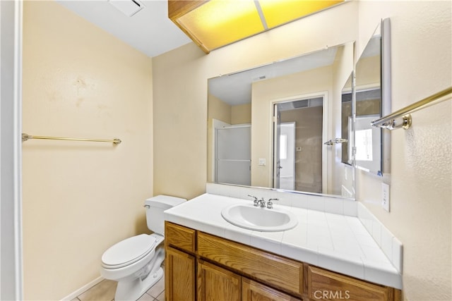 bathroom featuring tile patterned floors, vanity, and toilet