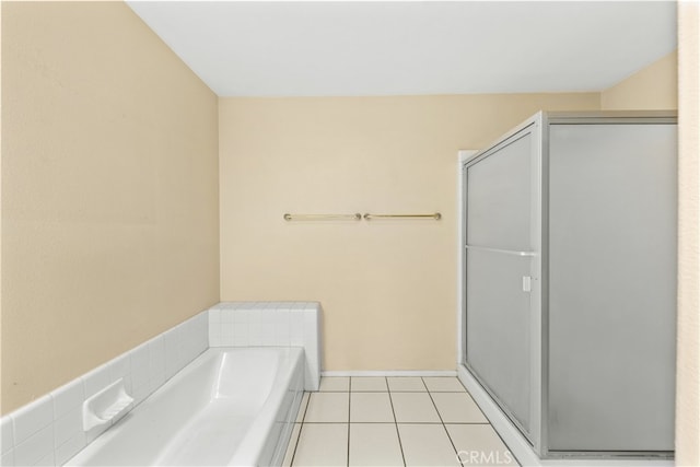 bathroom featuring tile patterned floors and shower with separate bathtub