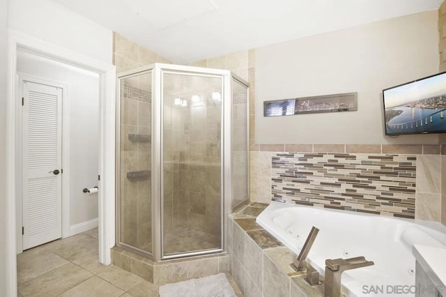 bathroom with separate shower and tub and tile patterned floors