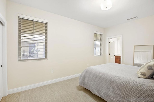 bedroom featuring light carpet