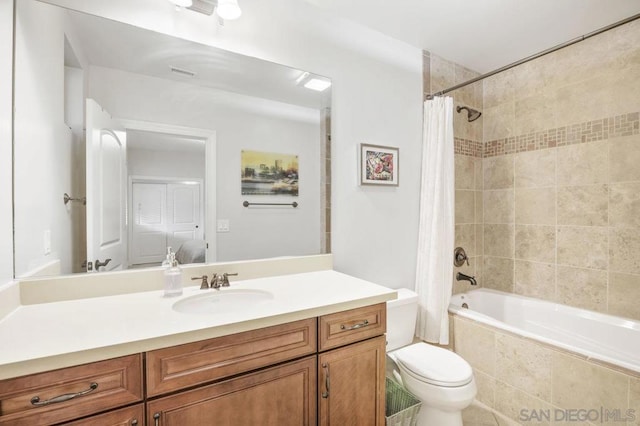 full bathroom with vanity, toilet, and shower / bath combo with shower curtain