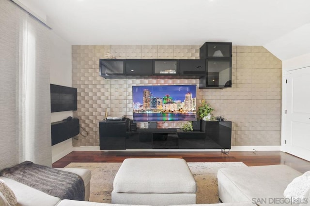 living room with vaulted ceiling and dark hardwood / wood-style floors