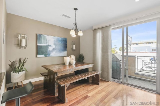 dining room featuring light hardwood / wood-style floors and a notable chandelier