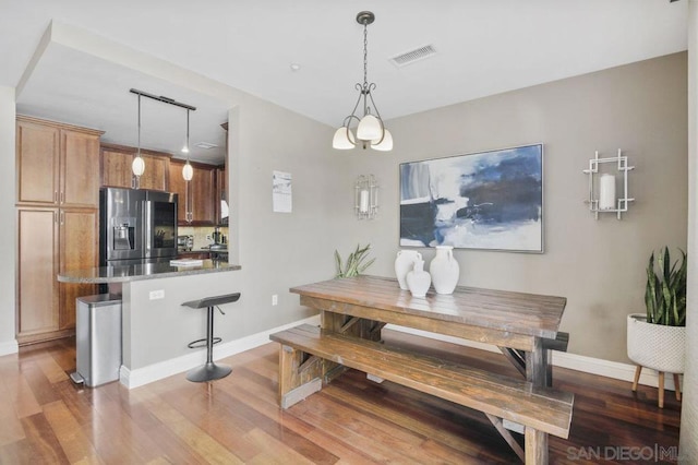 dining space with hardwood / wood-style flooring