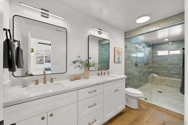 bathroom with vanity, hardwood / wood-style floors, toilet, and walk in shower