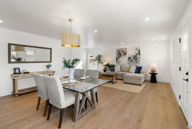 dining space with plenty of natural light and light hardwood / wood-style flooring