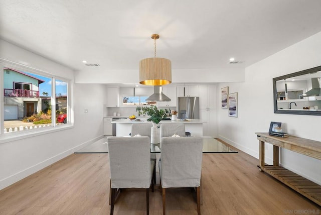 dining room with light hardwood / wood-style floors