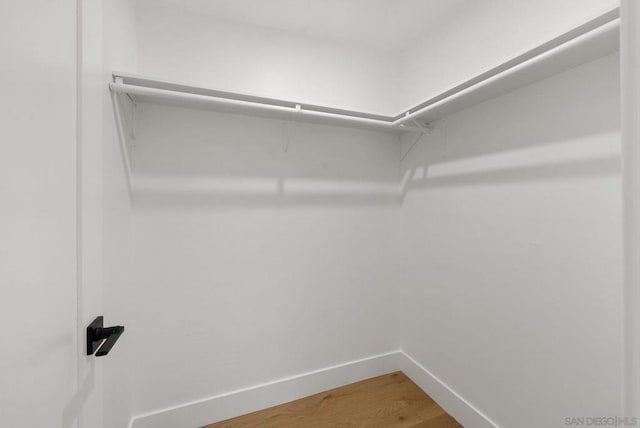 walk in closet featuring hardwood / wood-style flooring