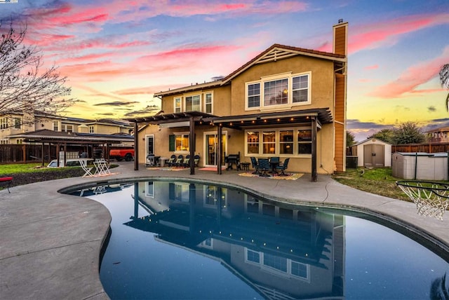 pool at dusk with a patio, a pergola, a shed, and central air condition unit