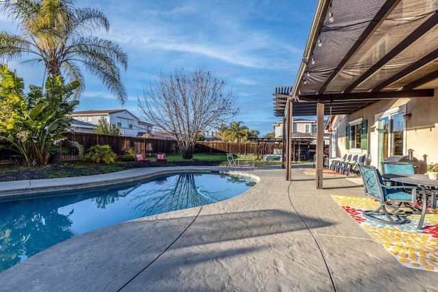 view of swimming pool with a patio and a pergola