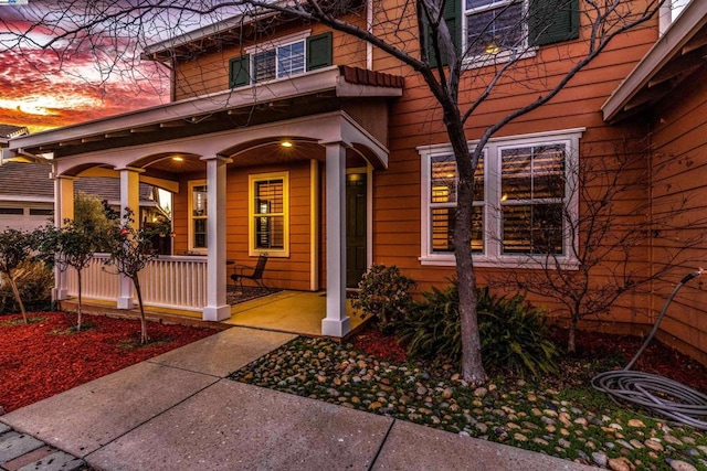 view of exterior entry with covered porch