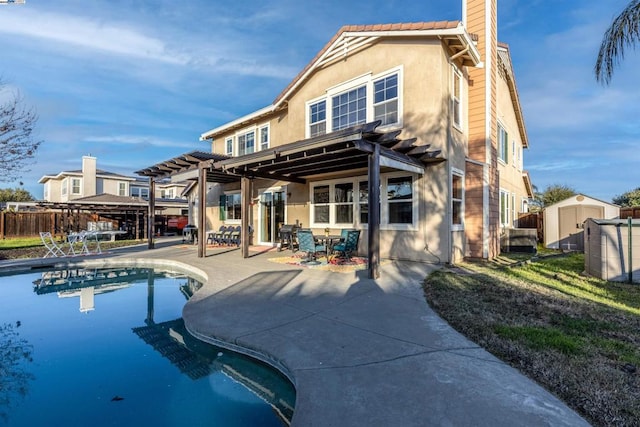 back of property featuring a fenced in pool, a patio, a pergola, and a storage shed