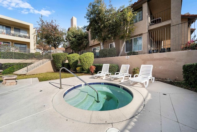 view of swimming pool featuring a patio area and a community hot tub